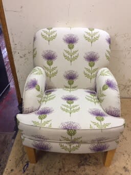 High-back armchair in pale floral patterned fabric