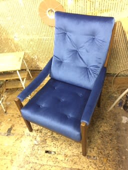 Blue leather chair with buttoned back on a workshop floor