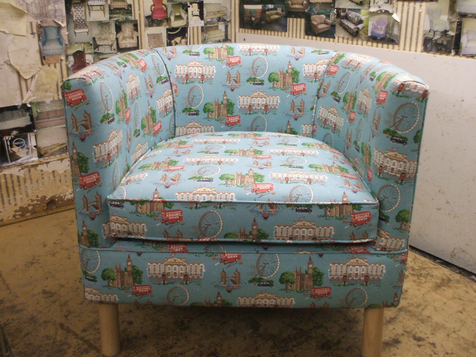 Re-upholstered armchair in pale blue patterned fabric photographed in the workshop