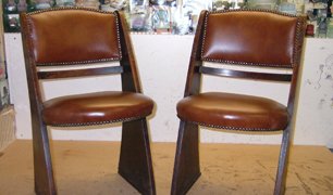 Pair of re-upholstered dining chairs in front of a fabric sample wall